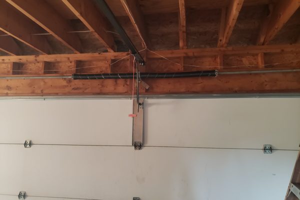 New matched torsion spring pair installed on the shaft after an emergency garage door repair in Virginia Beach