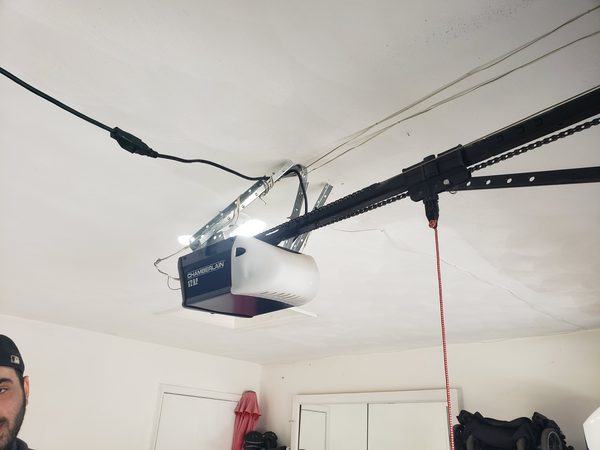 Chamberlain chain-drive garage door opener freshly installed on the ceiling rail, actual Seaside Garage Door job in Hampton Roads