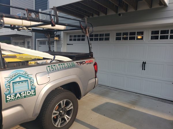Newly installed insulated steel carriage-style garage door on a Hilton Village home in Newport News, zip 23601, after a full same-day replacement.