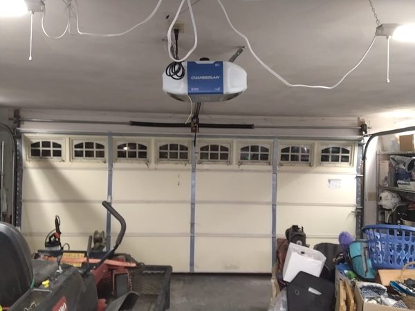 Double garage door closed and back on its tracks inside the garage, Chamberlain opener overhead, after the midnight repair