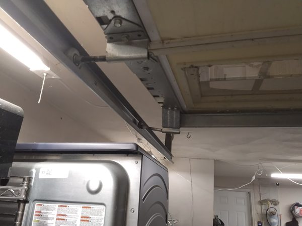 Garage door stuck in the open position overhead with a roller riding out of the horizontal track, Portsmouth, around midnight