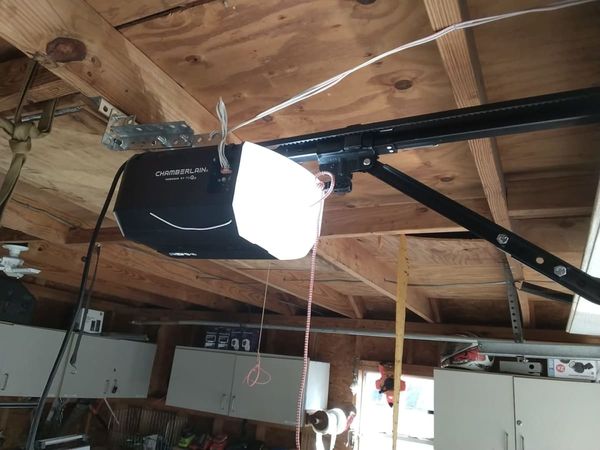 Garage door opener installation in Virginia Beach: new Chamberlain belt-drive opener hung on galvanized punched angle iron in a low-headroom Bayside garage, October 22, 2026