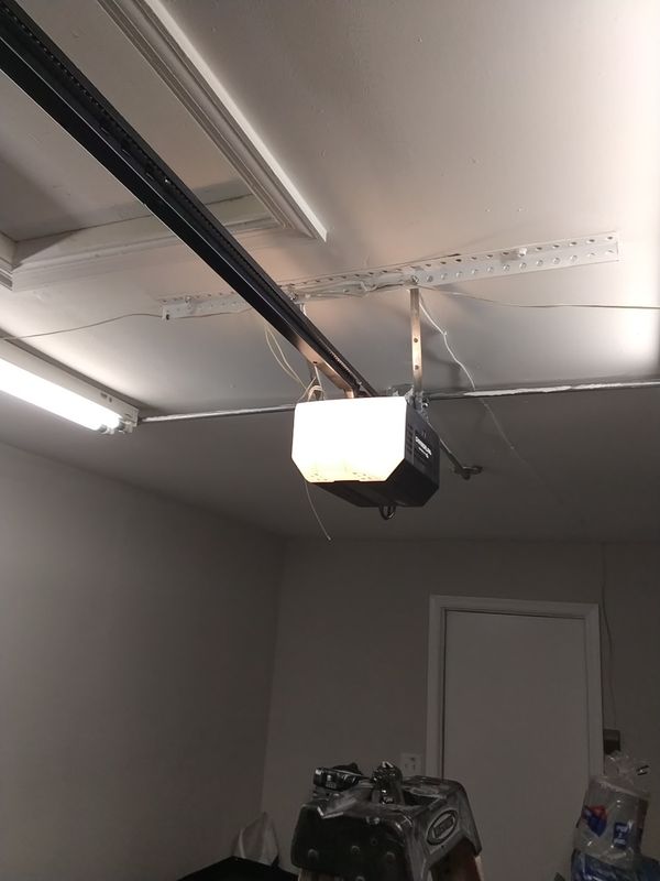 Garage door opener replacement Virginia Beach: new homeowner-supplied opener mounted on the ceiling after installation