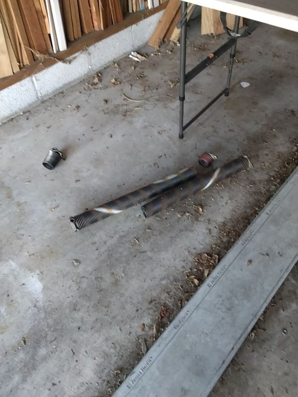 Garage door repair in Virginia Beach: the two old torsion springs removed from a door in ZIP 23455 that would not lift, September 3, 2026