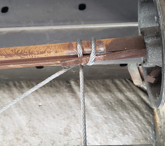 Seaside technician replacing a snapped garage door lift cable on a 16x7 steel door in Greenbrier, Chesapeake 23320