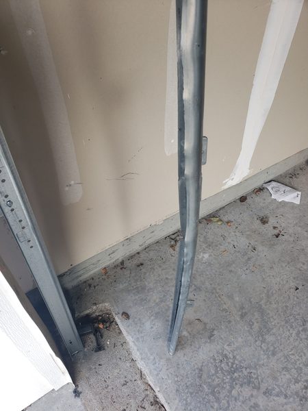 Replacing a rust-pitted track section on a coastal Virginia Beach garage door where salt-air corrosion compromised the wear surface