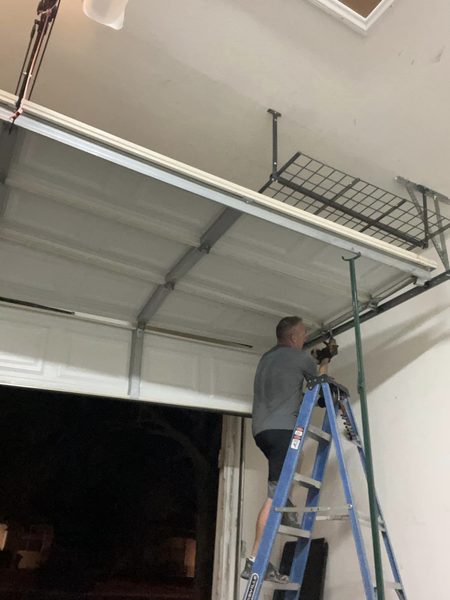 Seaside technician resetting an off-track garage door at a Buckroe Beach home in Hampton 23664 after a vehicle strike